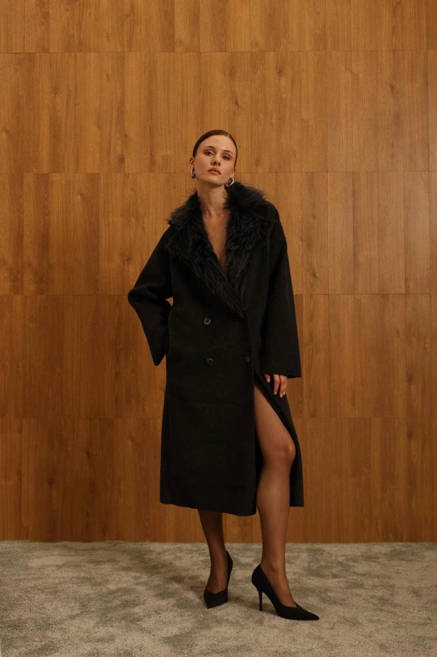 Voluminous ink-hued mantle with feathery animalia adornment, showcasing twin-row buttoning and a bold leg opening. Fa...