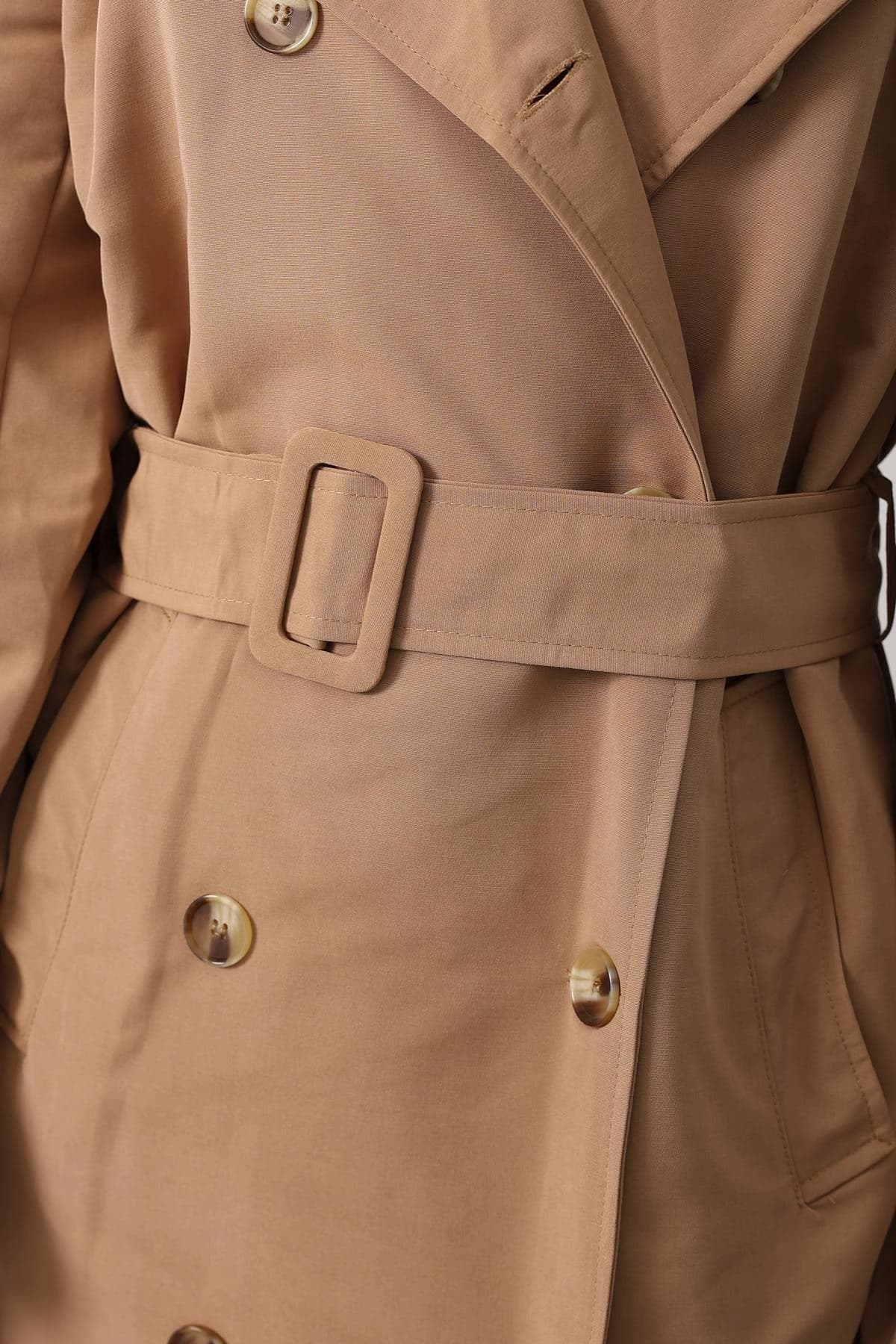 Desert-hued jacket, midriff defined by a sash with a flat-loop fastener, displaying twin patterned disc fastenings an...