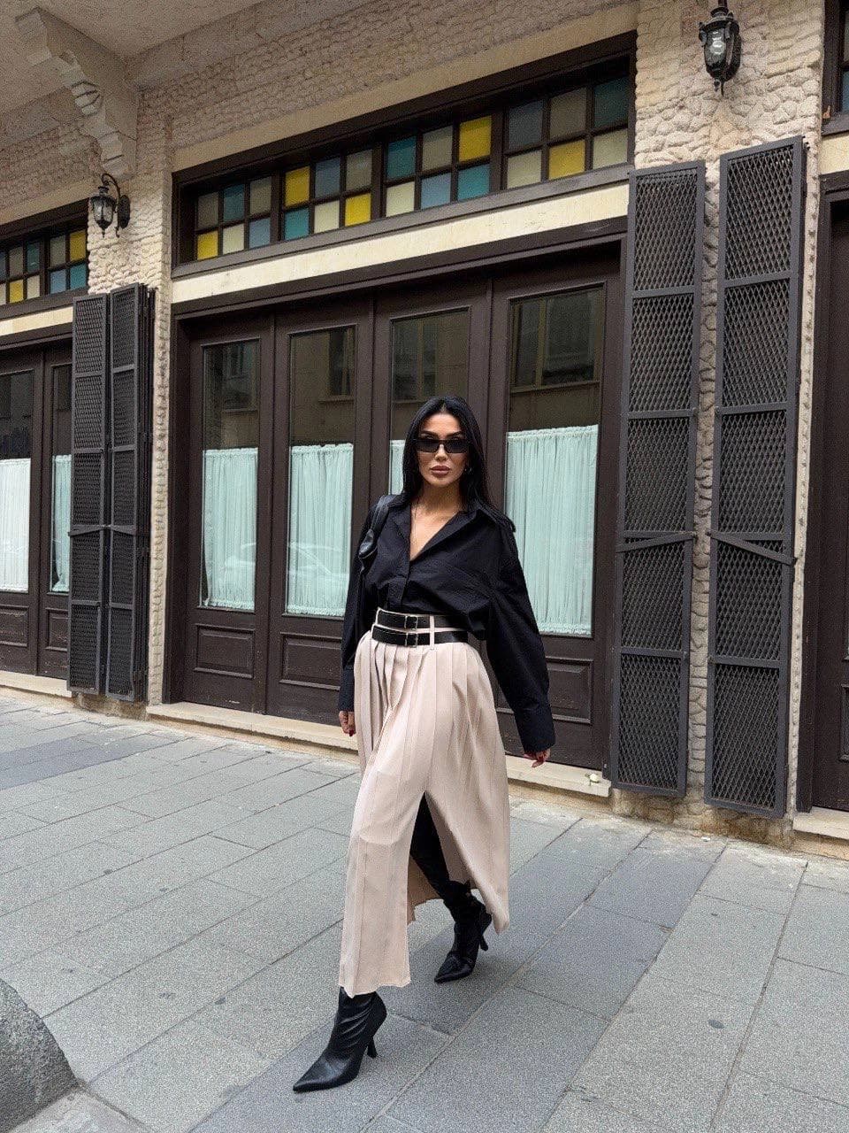 Creamy calf-grazing apparel with vertical creases & tall front vent, cinched by a midnight dual-clasp waist accent. U...