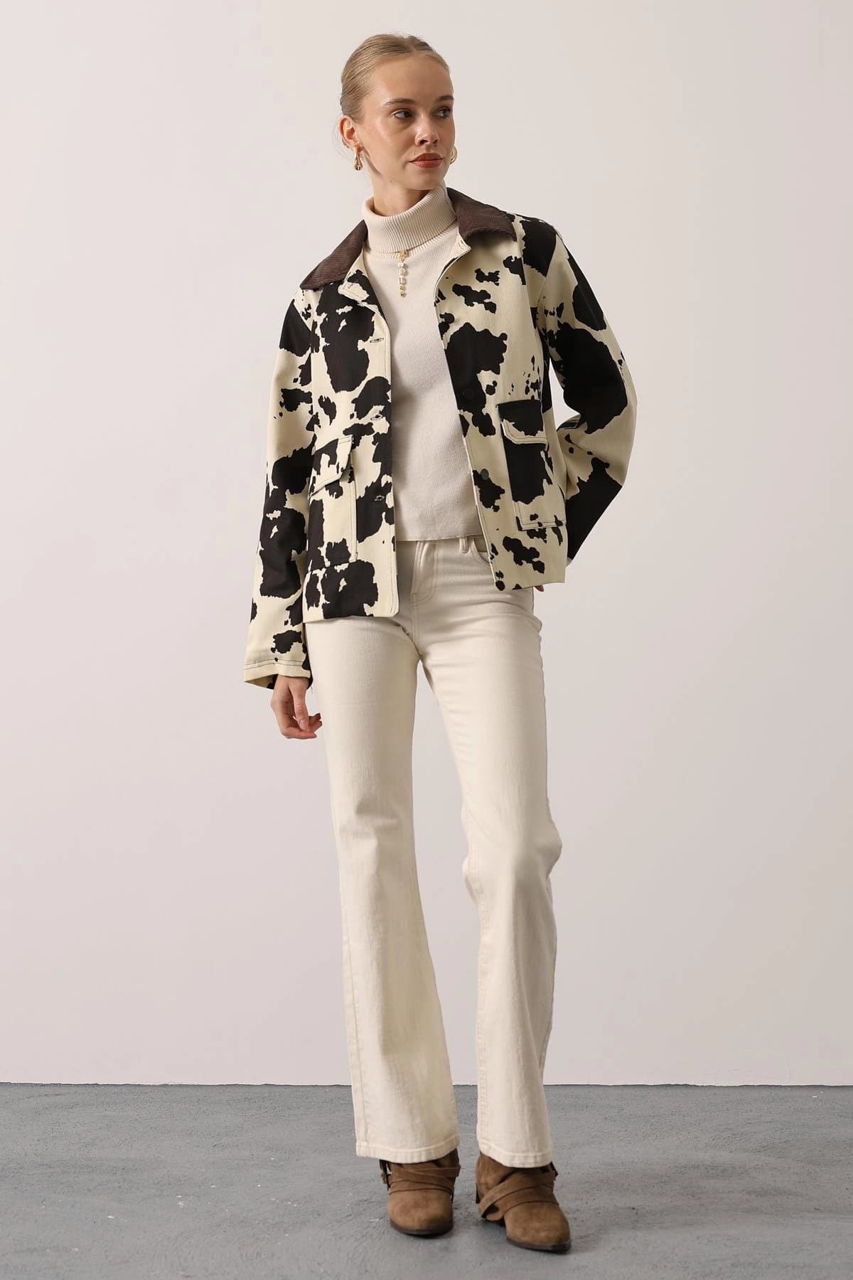 Women's short overcoat, off-white with irregular black markings, earthy-toned fabric collar, secured front, practical...
