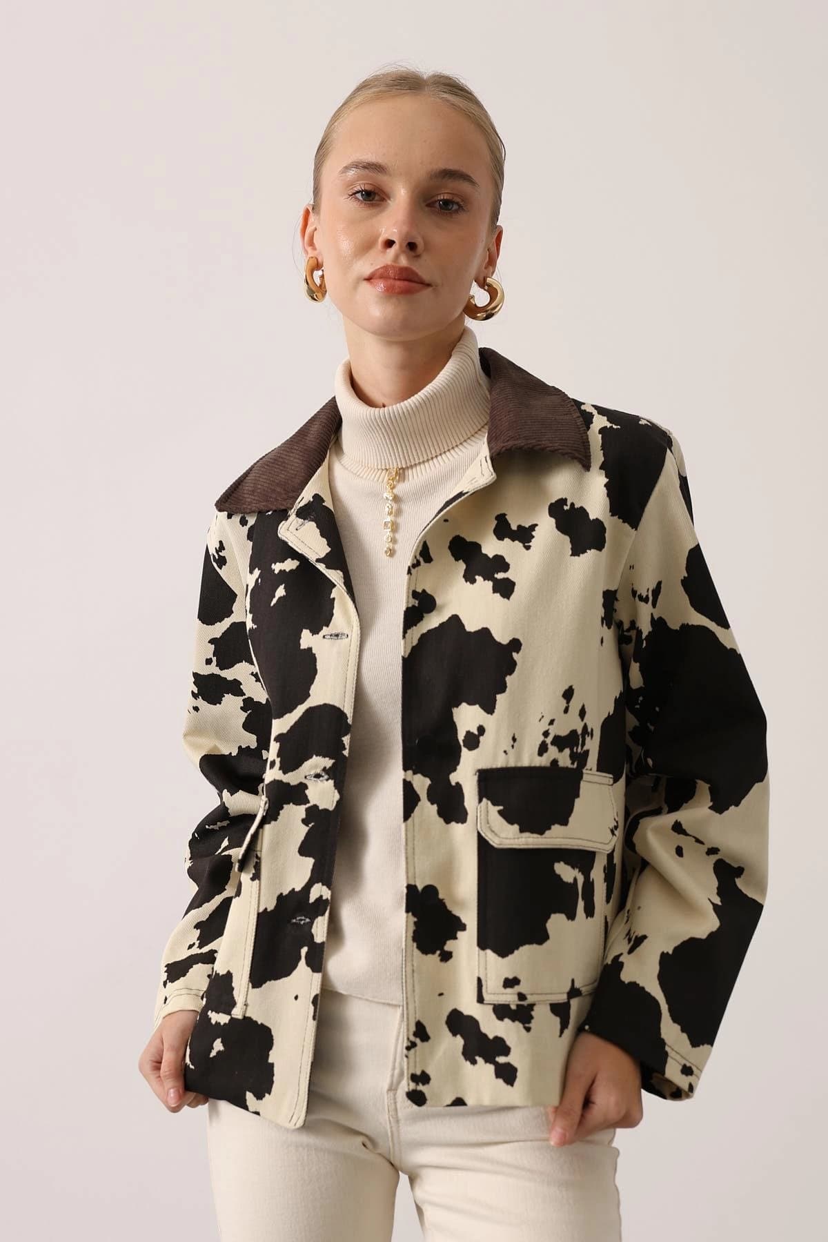 Woman's over-shirt featuring patchy animal design in pale buff & sable, chocolate wale collar, central button fasteni...