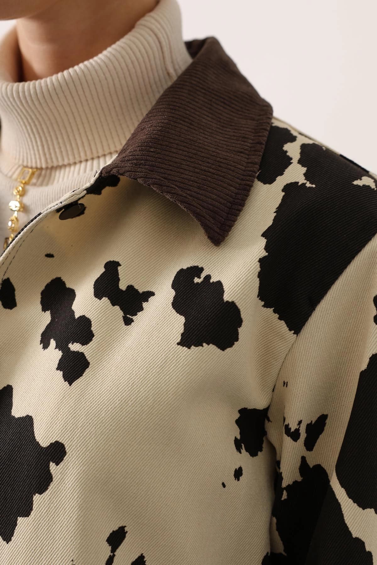 Boho jacket: creamy base adorned with bold ebony blotches, featuring a deep cocoa ribbed cord collar, women's outerwear.